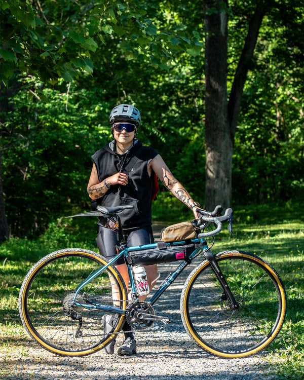 Person with a bicycle in a park setting